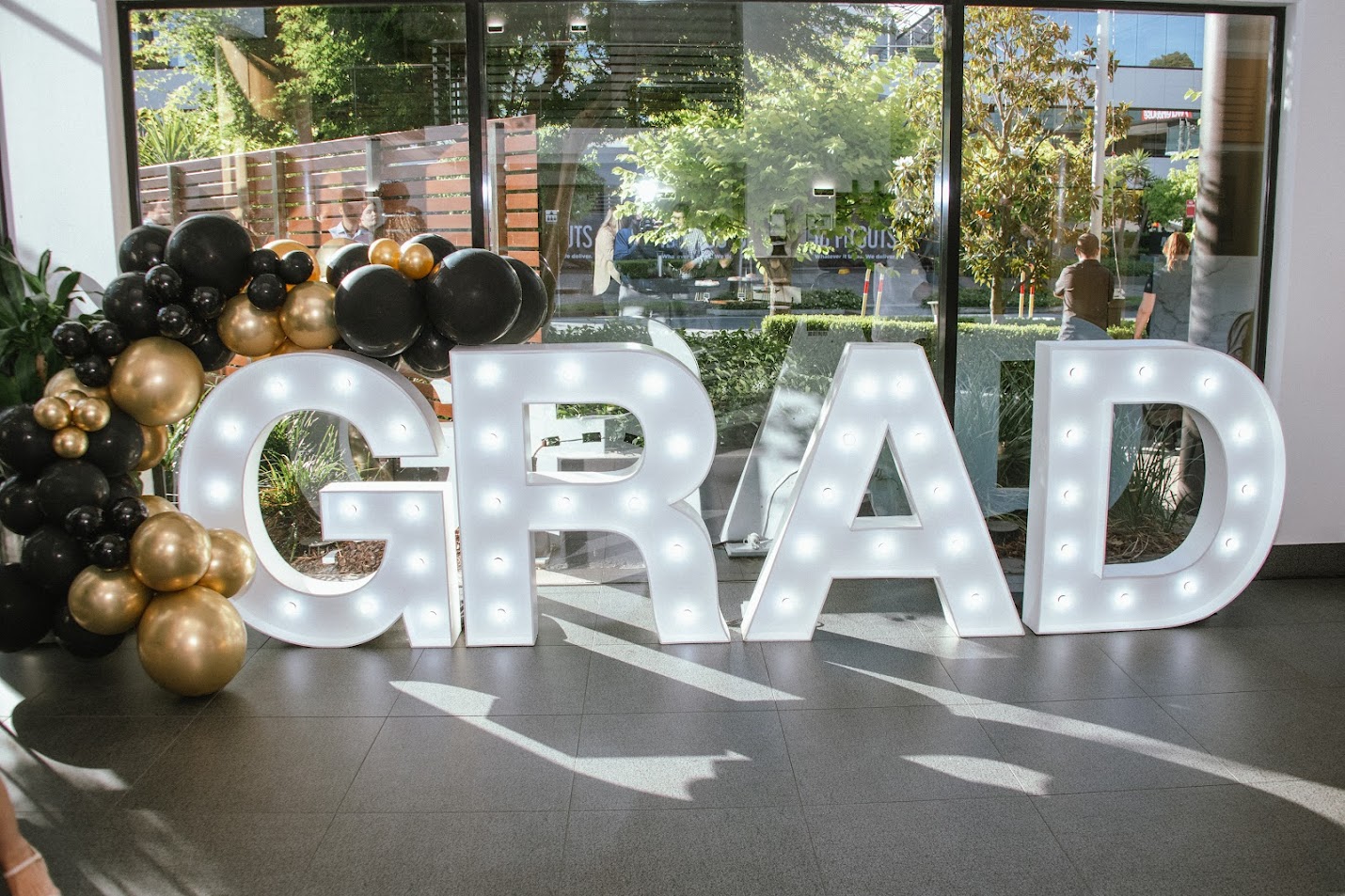 GRAD lit up with giant light up letters to celebrate McDonald's Graduates.