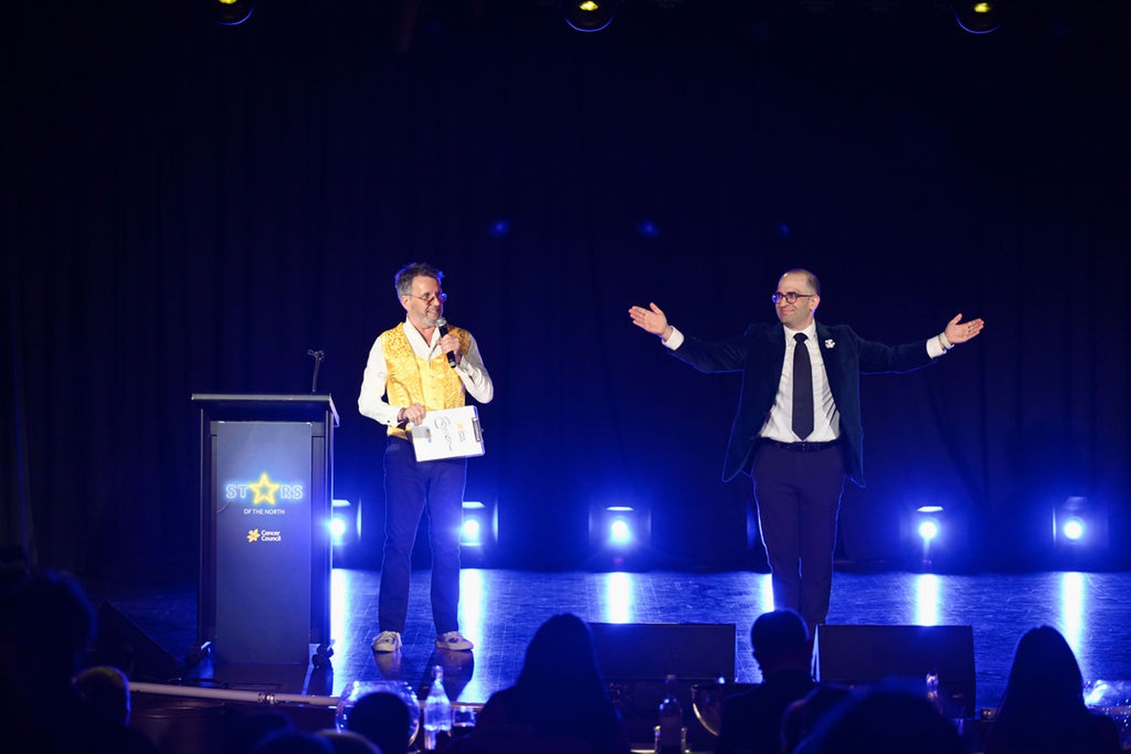 MCs on stage at the Stars of the North lectern, Norths Cammeray